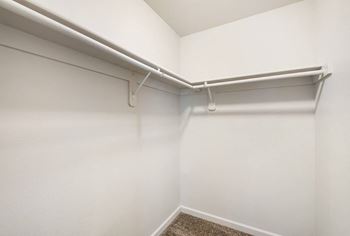 An empty room with a white wall and a white closet